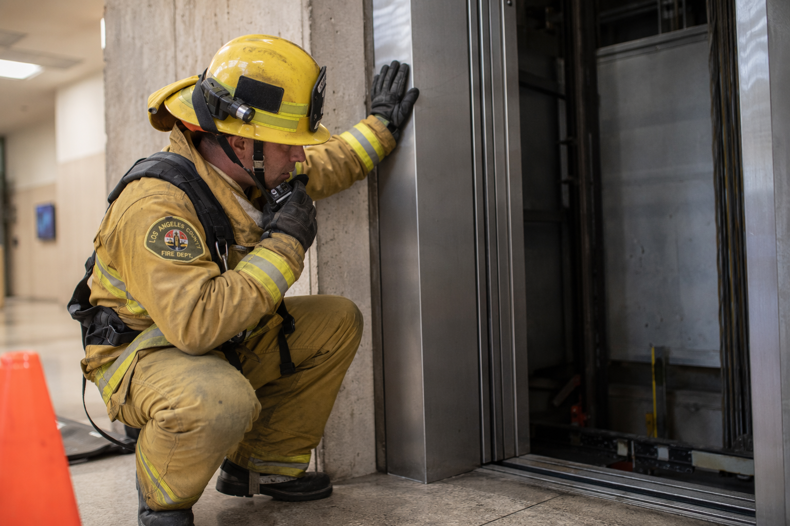 Los Angeles County fire rescue technician responding to an elevator entrapment, illustrating when to call 911 instead of the elevator emergency phone number.