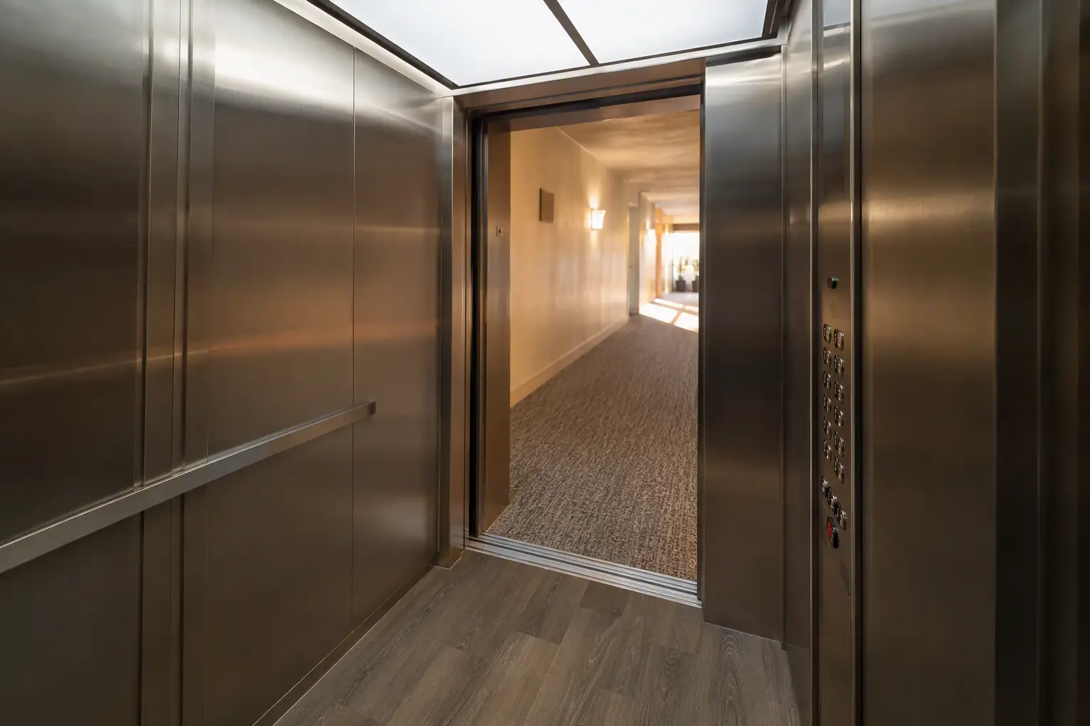 Newly modernized elevator cab interior with ADA-compliant fixtures and updated finishes in a Southern California residential building, showing 2027 modernization results.