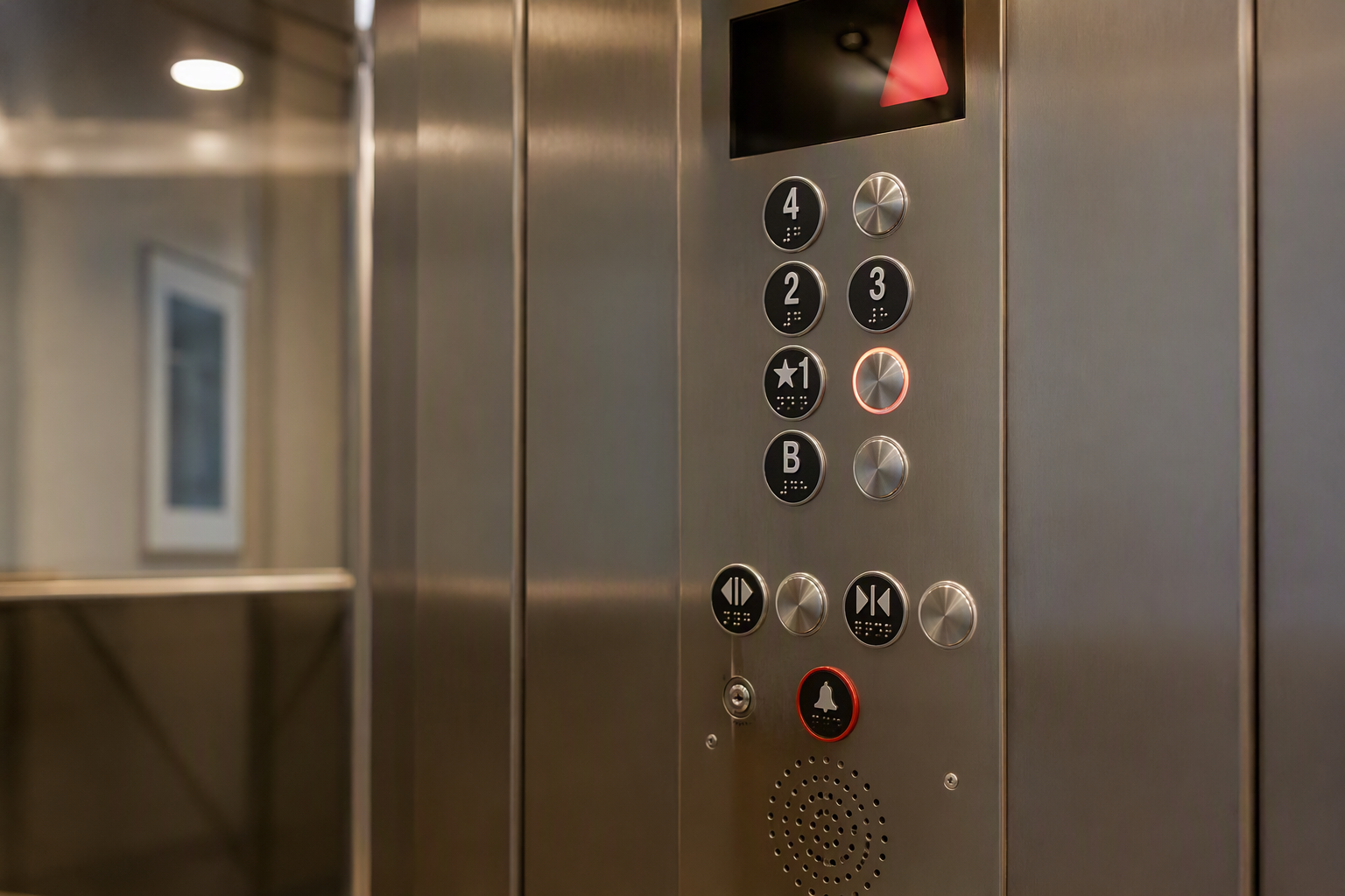 ADA and Title 24 compliant elevator control panel with Braille buttons, accessible dual-height layout, and emergency two-way communication system inside a California multifamily building
